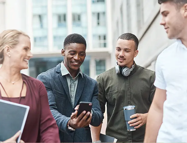 Students smiling and seeing a phone